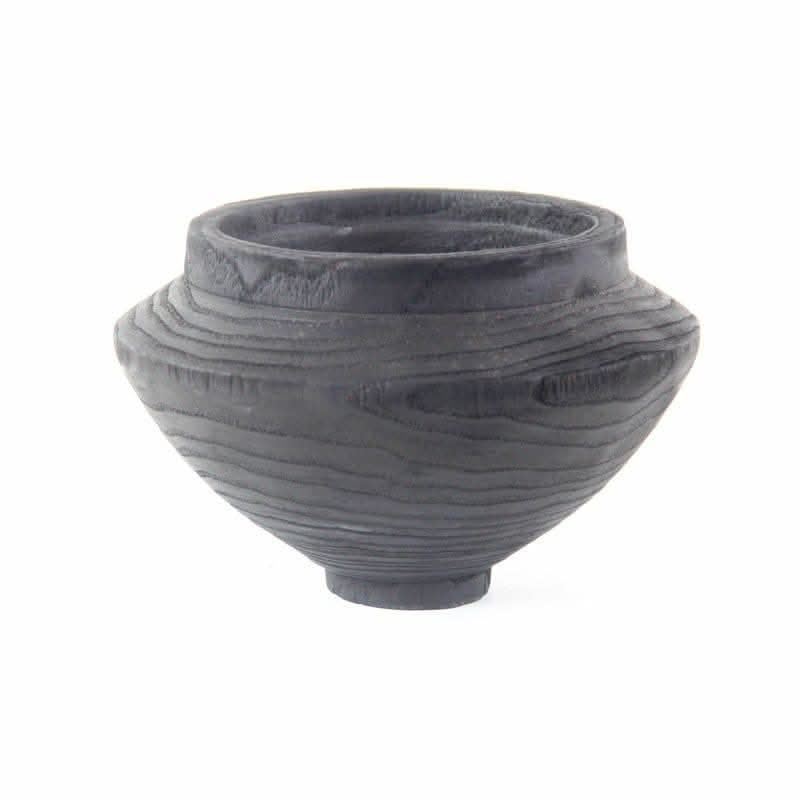 Dark wood handmade black bowl with visible grain texture on white background.